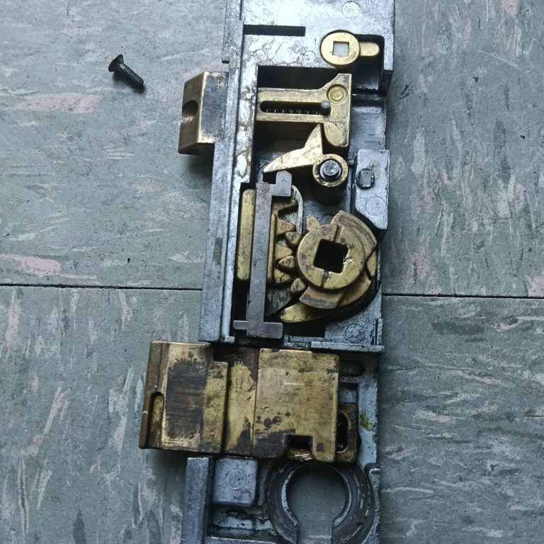 Internal multipoint door lock gearbox mechanism removed for repair
